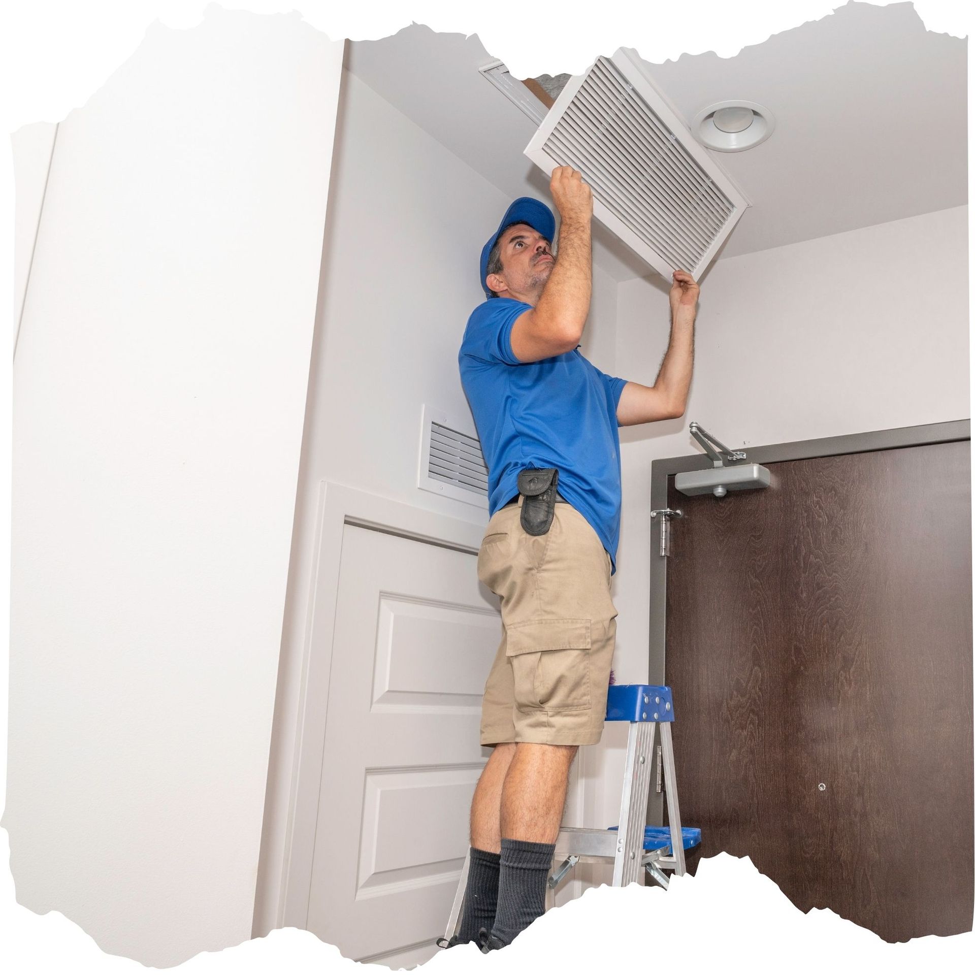 TSC-HVAC - A man is standing on a ladder fixing a ceiling fan.
