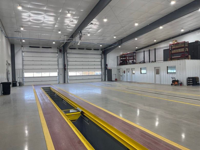 A large empty warehouse with a large garage door.