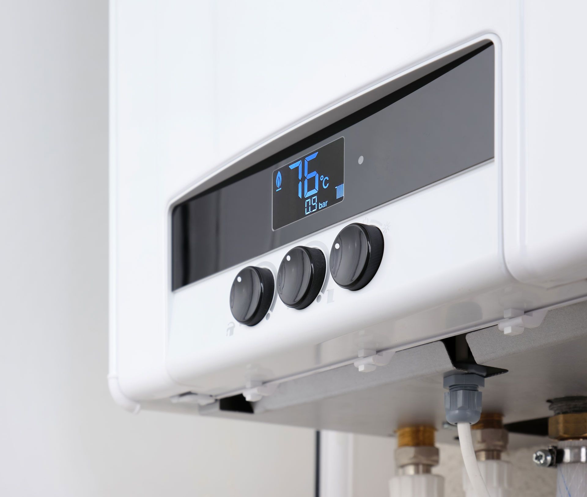 A close up of a white boiler with a digital display.