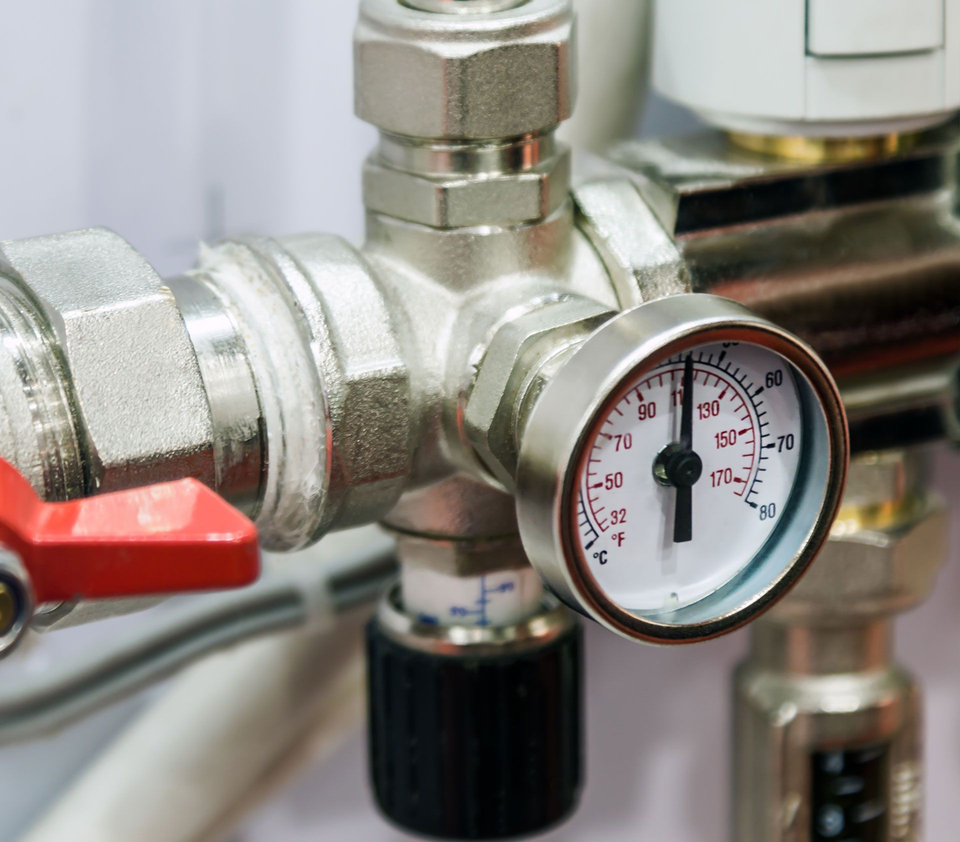A close up of a pressure gauge on a pipe