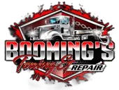 Logo for Booming's Towing & Repair, featuring a tow truck in front of a red and gray graphic design.