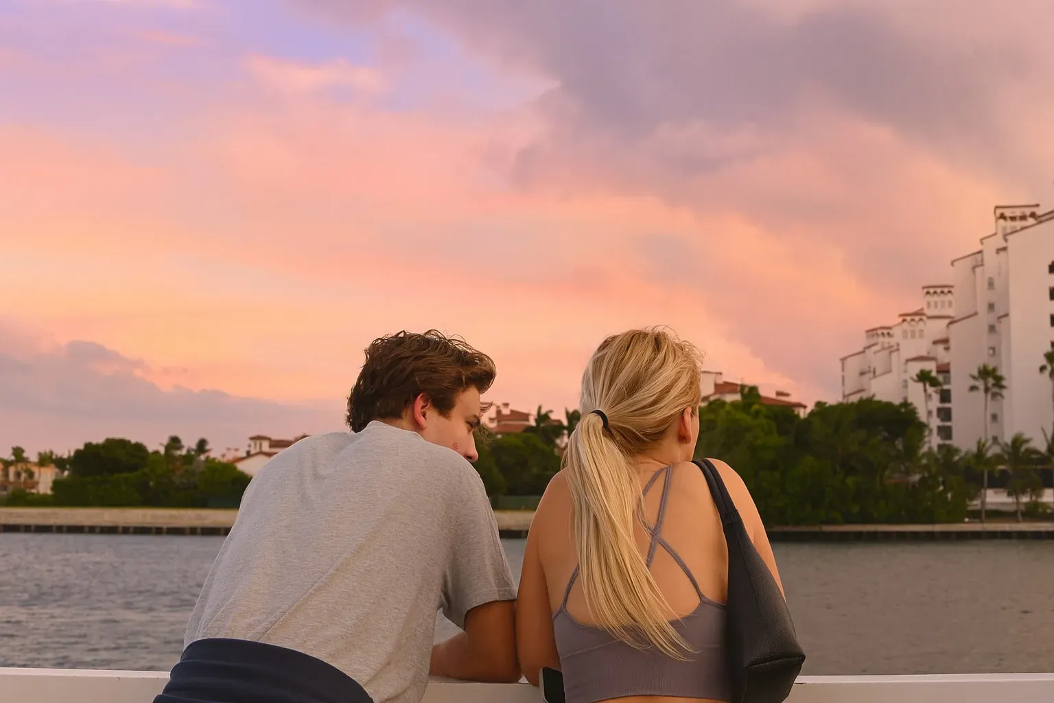 Couple sharing a quiet moment on a sunset cruise Miami with waterfront views.
