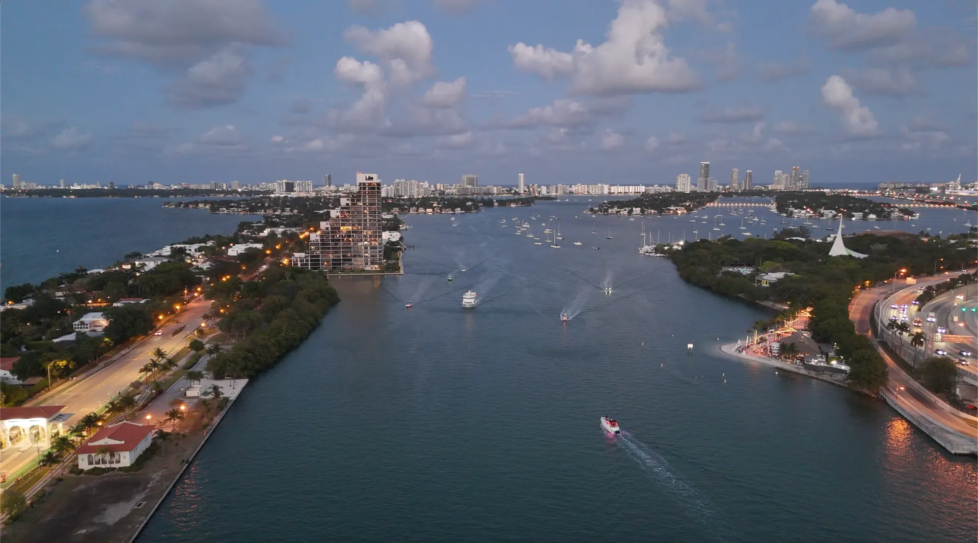 Sunset cruise Miami passing through calm waterways as the city transitions from daylight to evening.