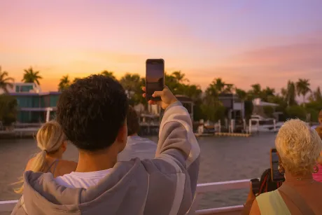 Guests enjoying sunset in Miami from the water during a Miami sunset boat cruise.
