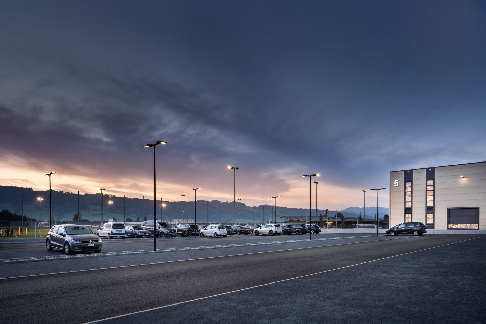 Parkplatz im Abendlicht mit Strassenlaternen