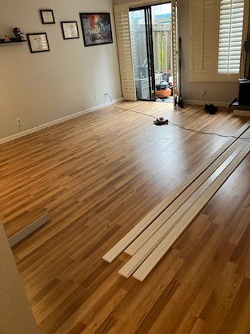 A living room with hardwood floors and a sliding glass door.
