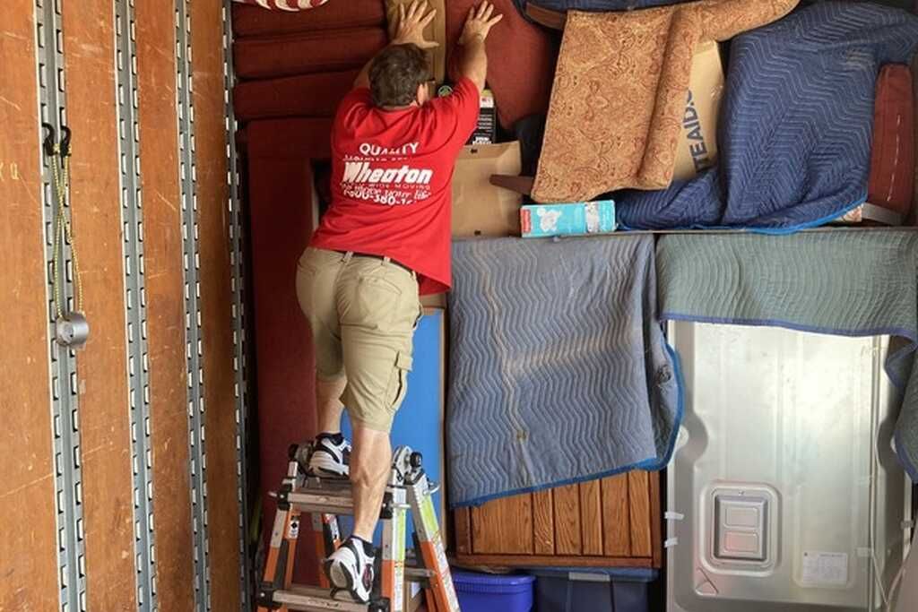 A man wearing a red shirt that says ' movers ' on it