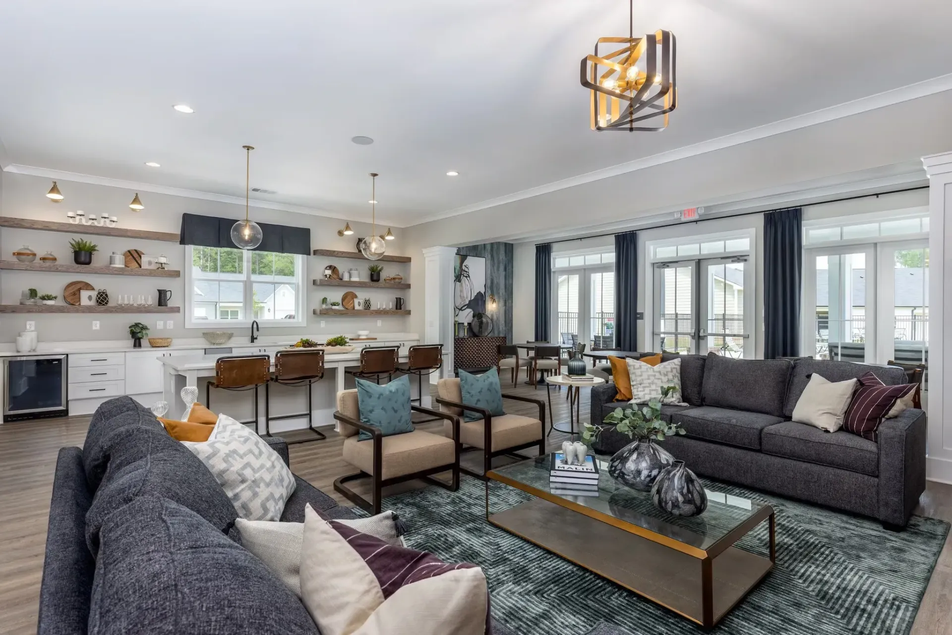 Modern lounge area with couches, armchairs, and a full-service bar.