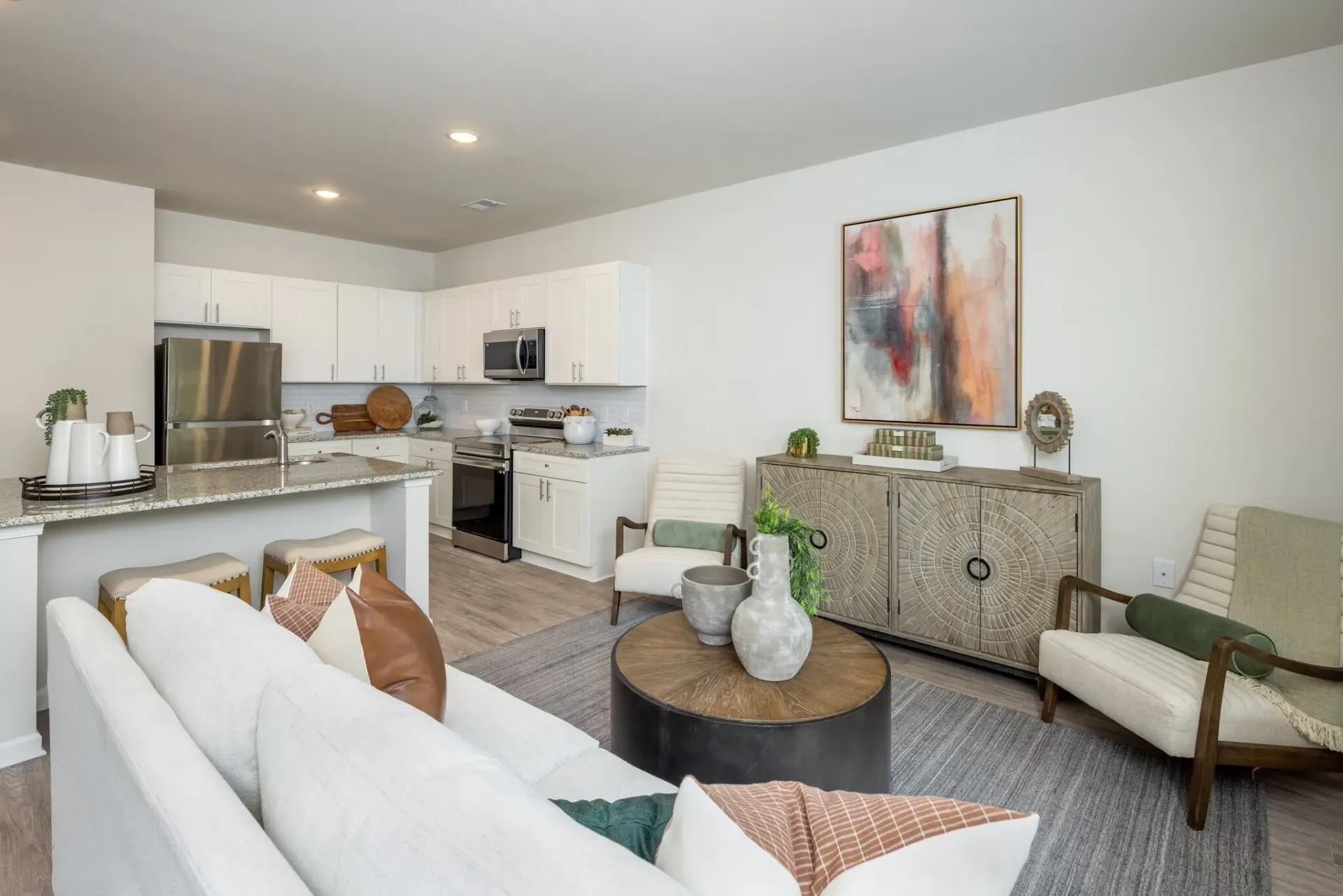 Open concept living area and kitchen with modern appliances and decor.