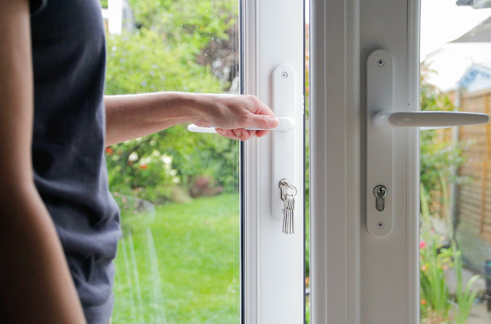 A person opens patio security doors.