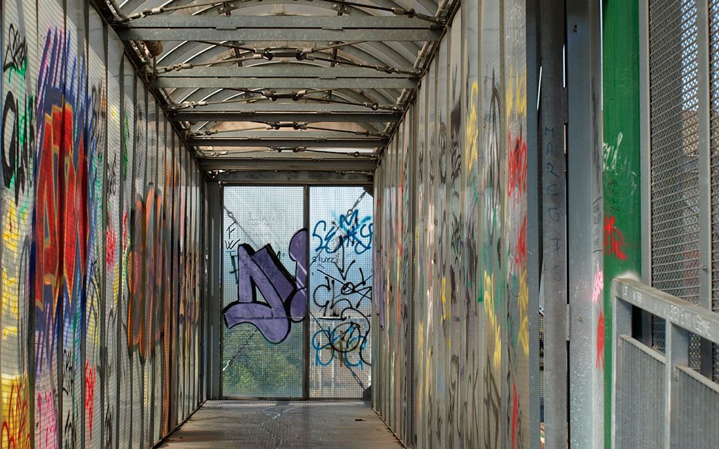 A long hallway with graffiti on the walls.