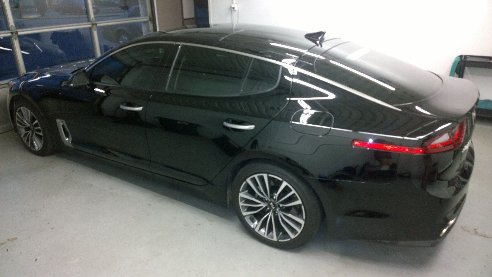 A black car is parked in a garage.