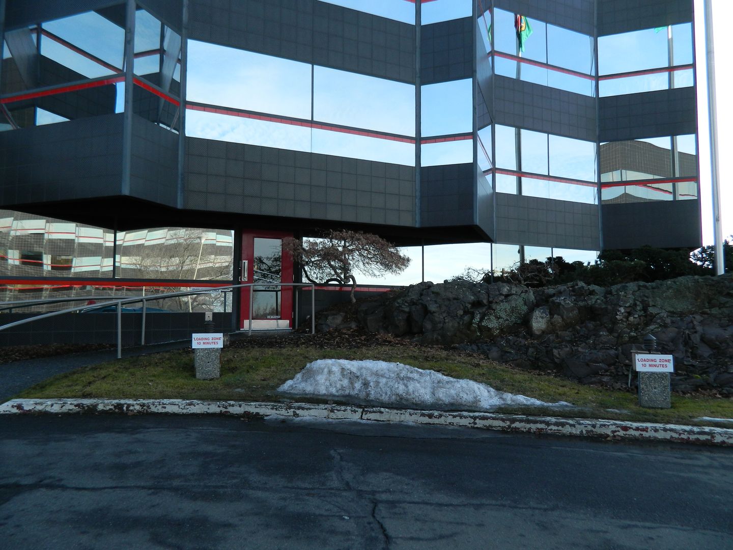 A building with a lot of windows and a sign that says no parking