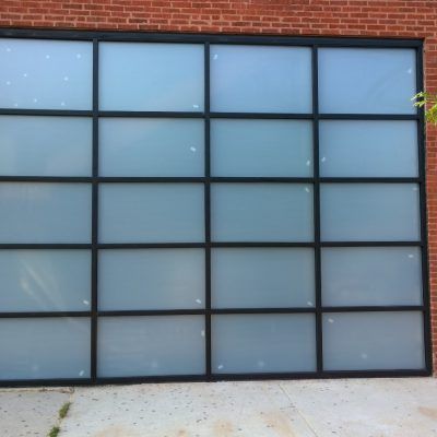 A brick building with a sliding glass garage door