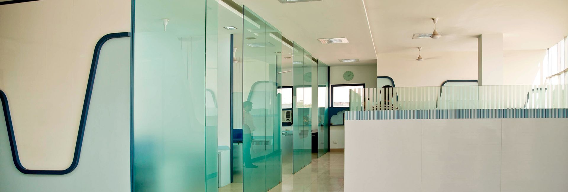 A hallway with sliding glass doors and a white wall