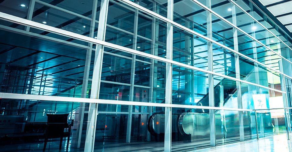 A building with a lot of windows and a escalator in the background.