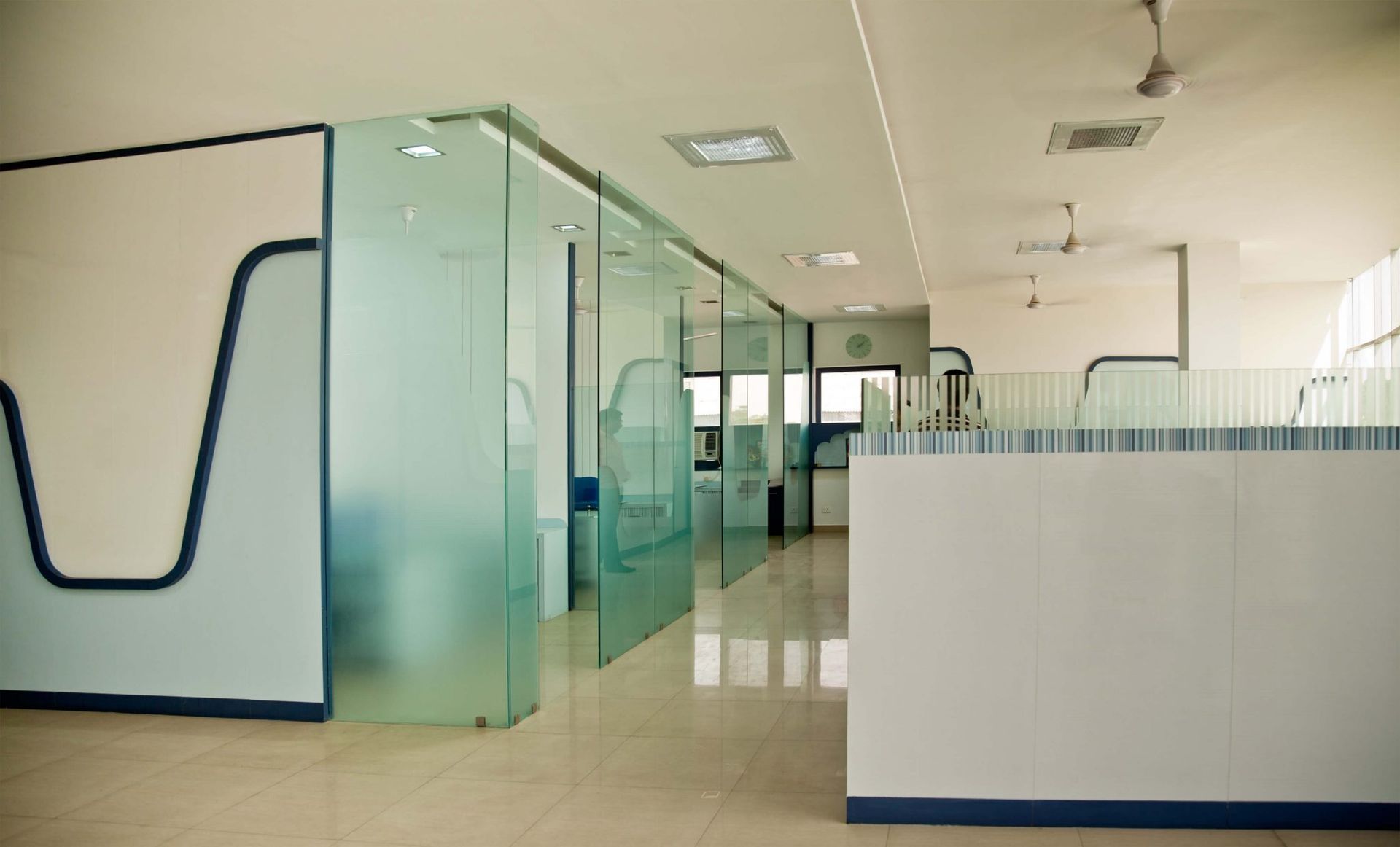 A room with a lot of glass doors and a ceiling fan.