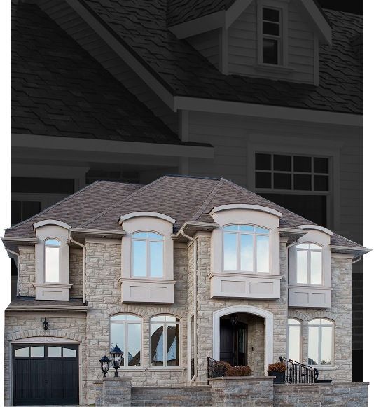 A large house with many windows and a black garage door