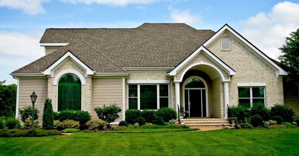 A large house with a large lawn in front of it
