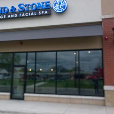 A building with a sign that says ' id & stone ' on it