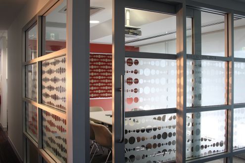 A conference room with a table and chairs in it