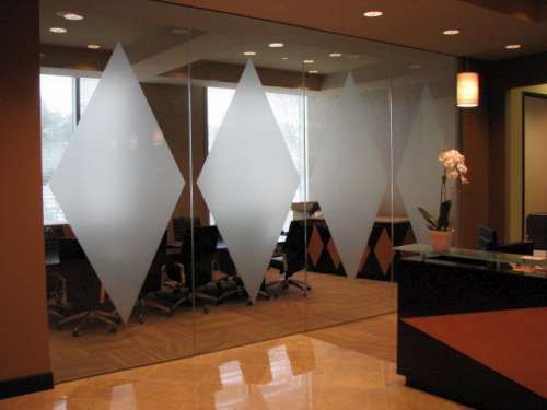 A conference room with a glass wall with diamonds on it