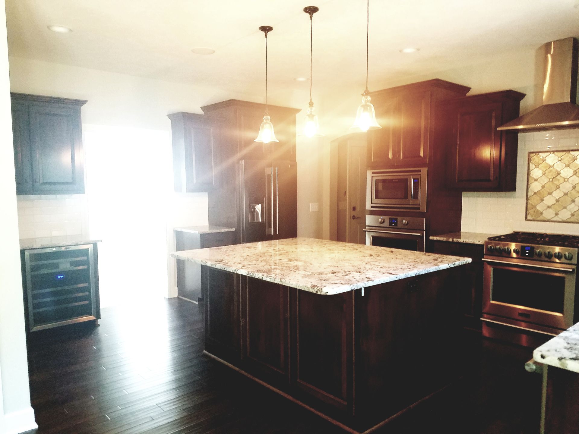 A kitchen with a large island and stainless steel appliances