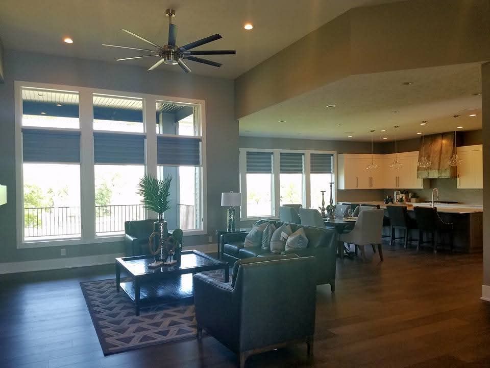 A living room filled with furniture and a ceiling fan.