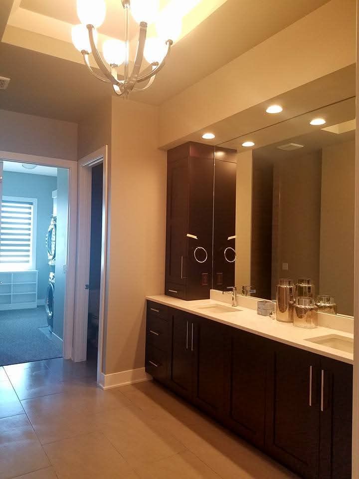 A bathroom with two sinks and a large mirror