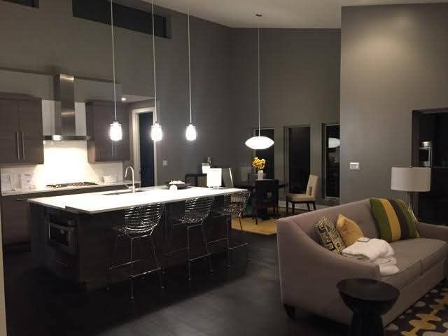 A living room with a couch and a kitchen