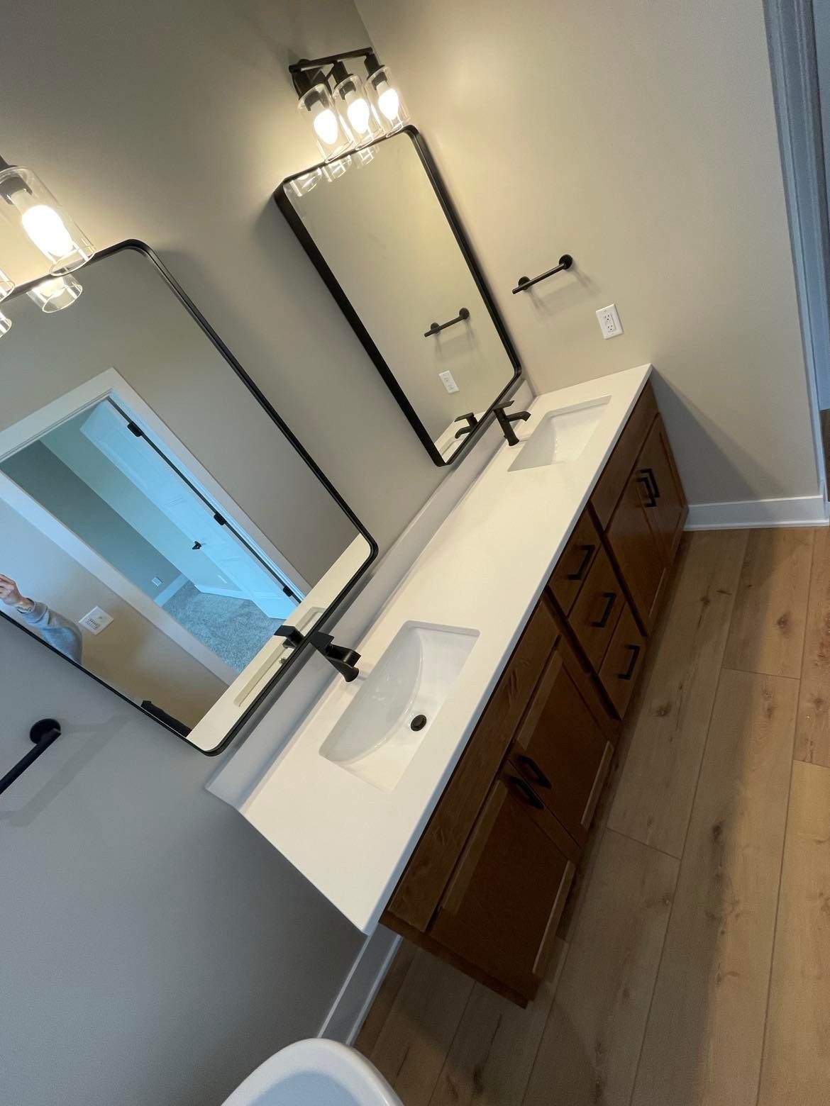 A bathroom with two sinks and two mirrors