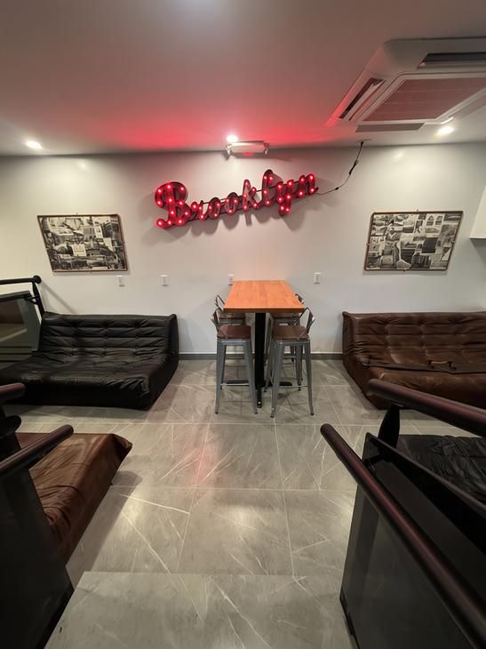 Room with three black couches and a