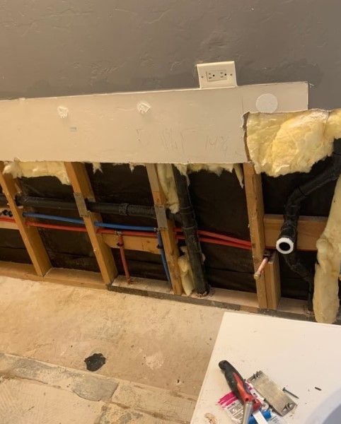 A wall with a lot of pipes coming out of it