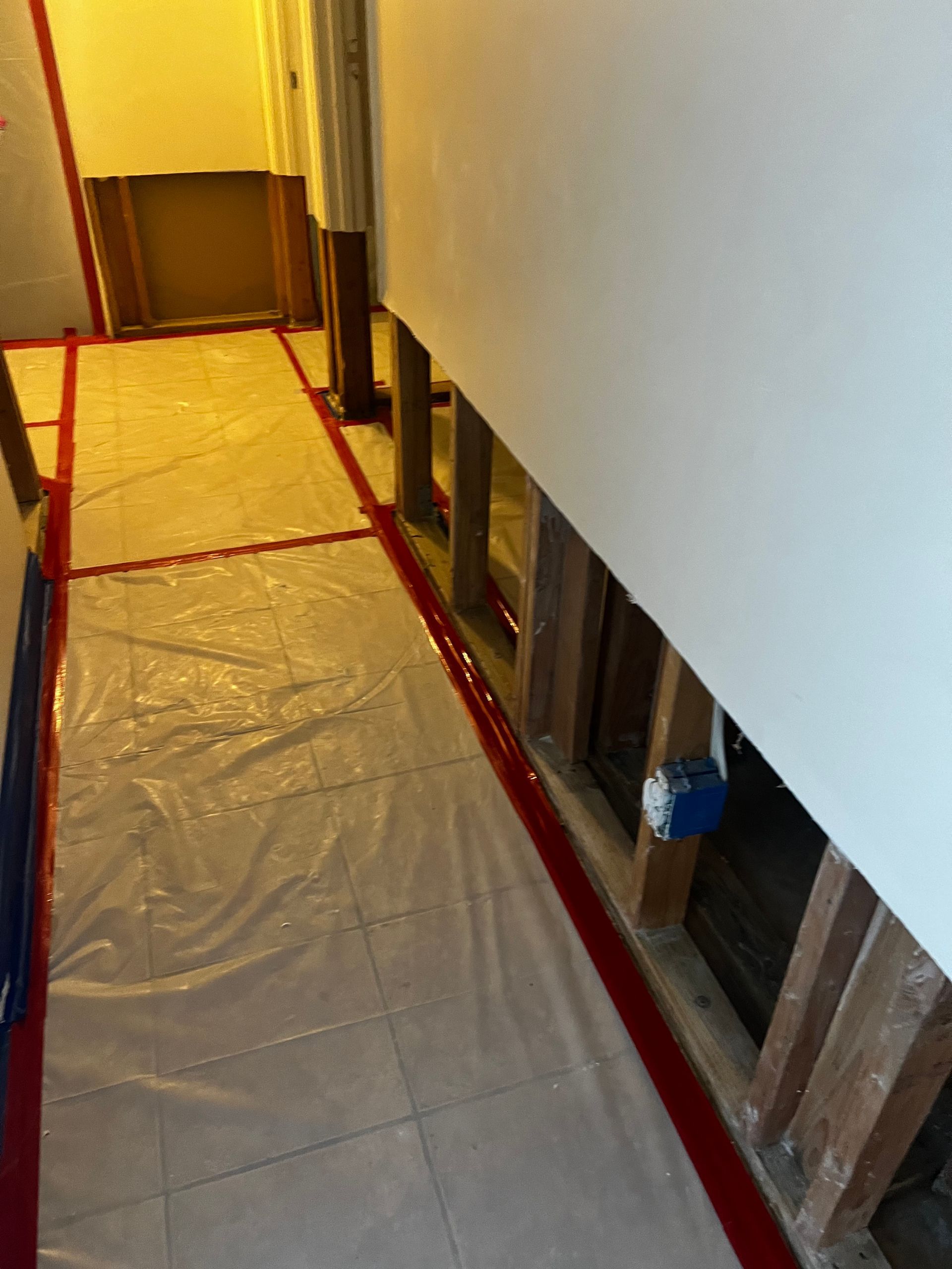 A hallway with a plastic sheet on the floor