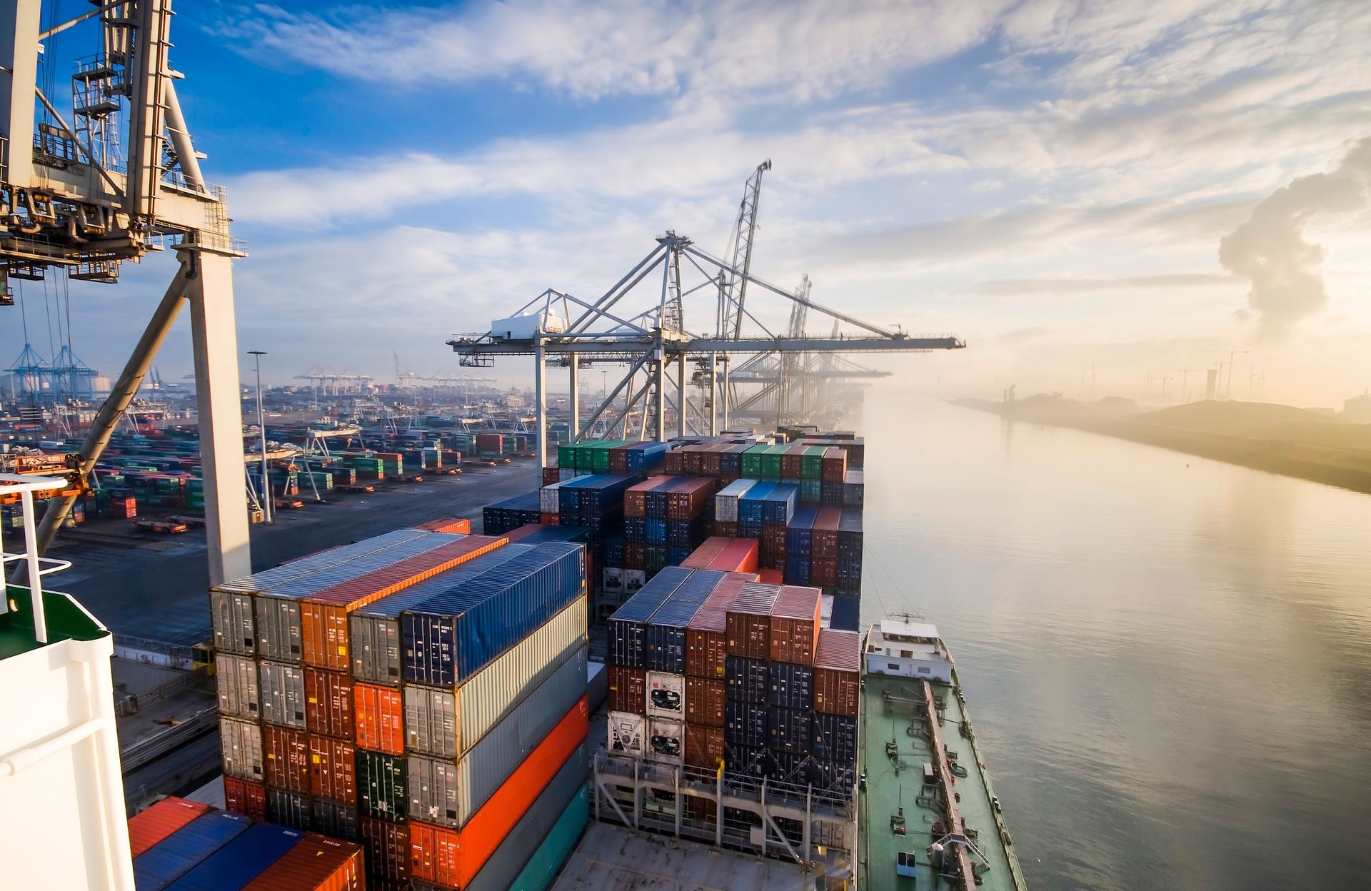 An aerial view of a large container ship in a harbor.