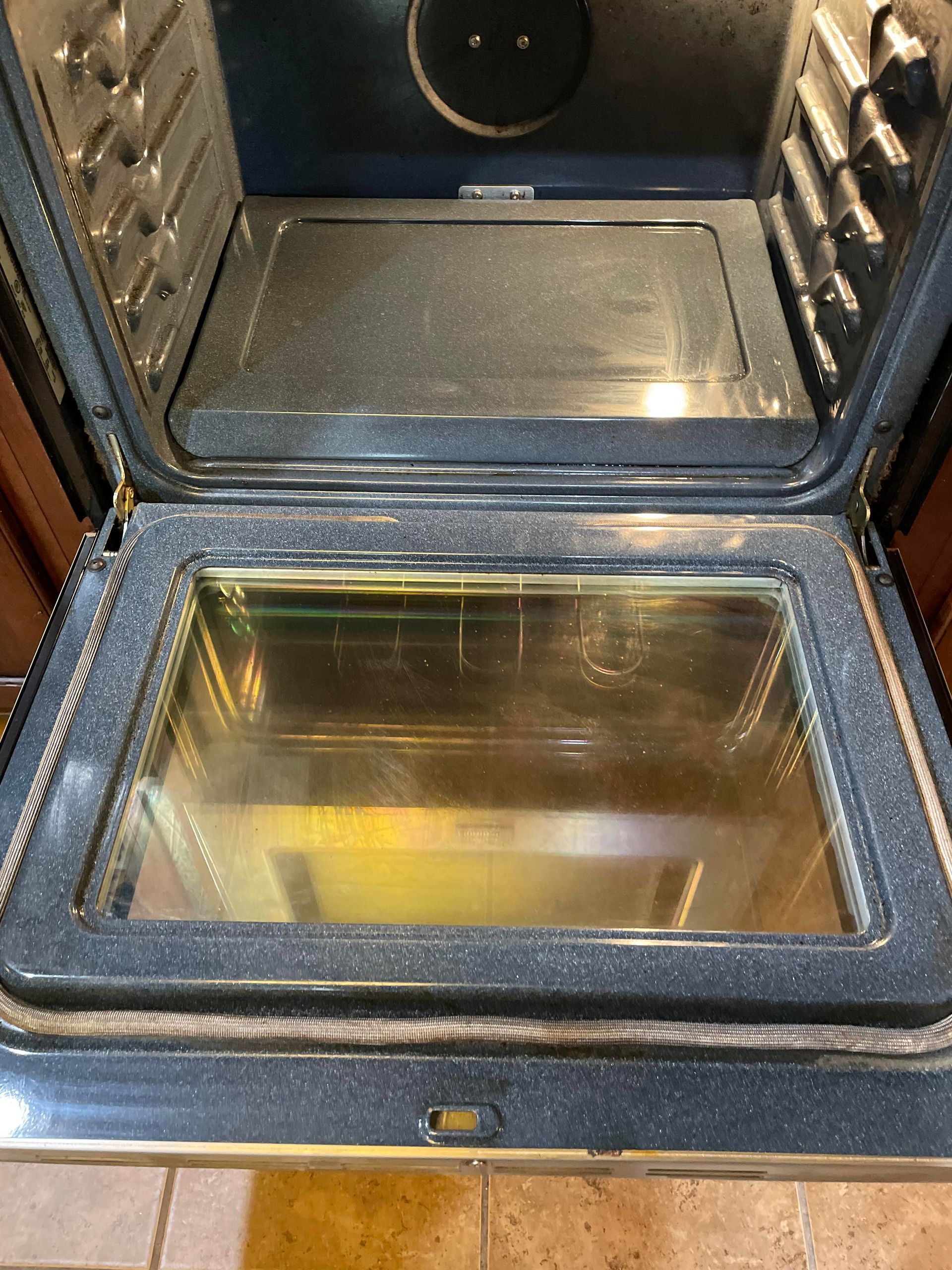 The inside of a clean oven with the door open.