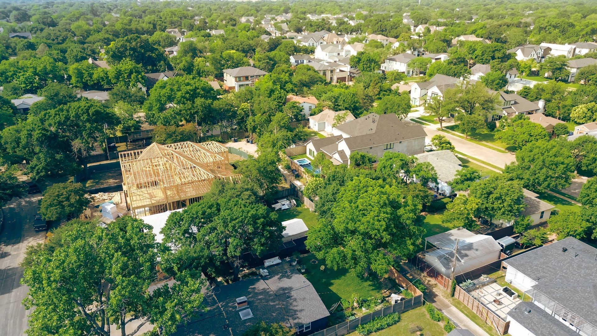 Aerial of lush, green trees and a developing neighborhood near Dallas, TX, south of Celina, TX
