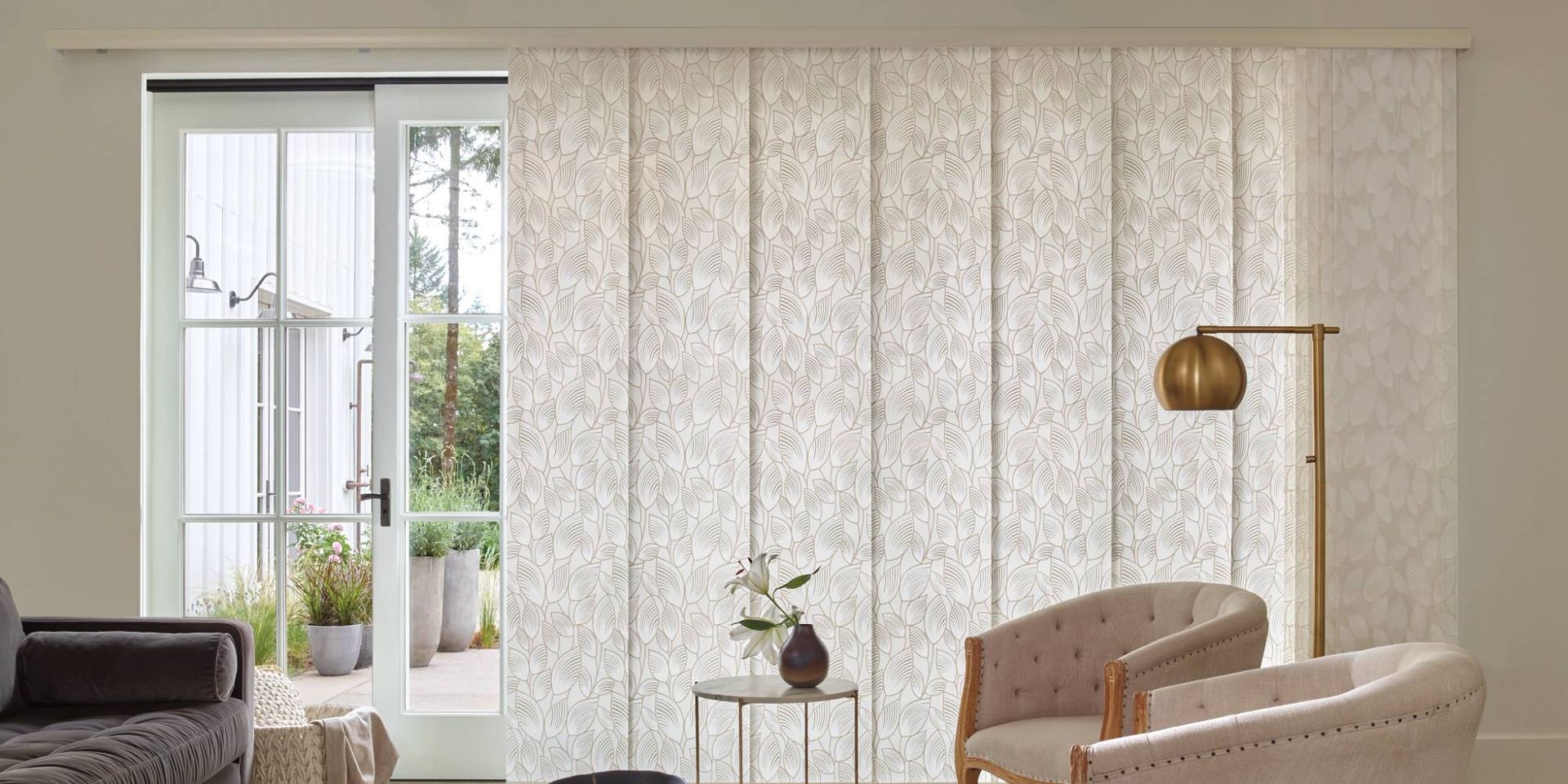 Patterned Hunter Douglas Skyline® Panel-Track Blinds on an expansive sliding door in a living room