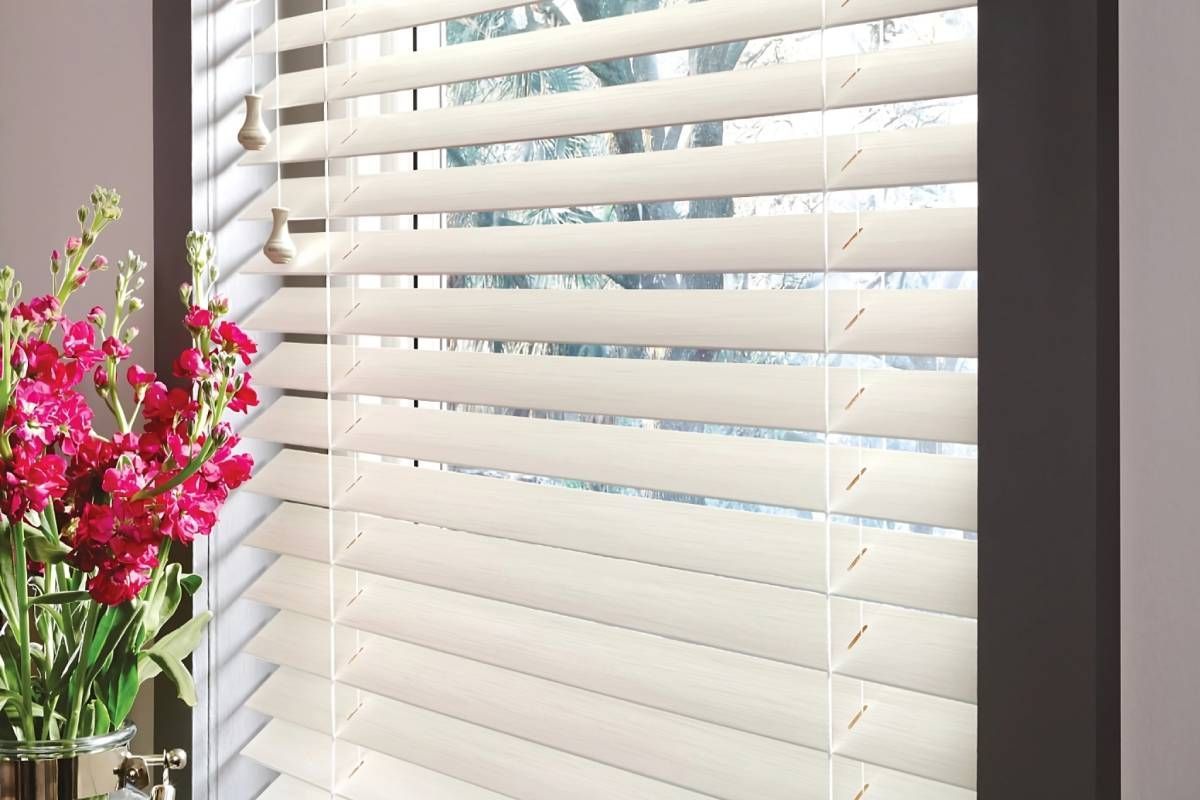 White Hunter Douglas Parkland® Wood Blinds, from Advantage Blinds, on a window near pink flowers near Prosper, Texas (TX)
