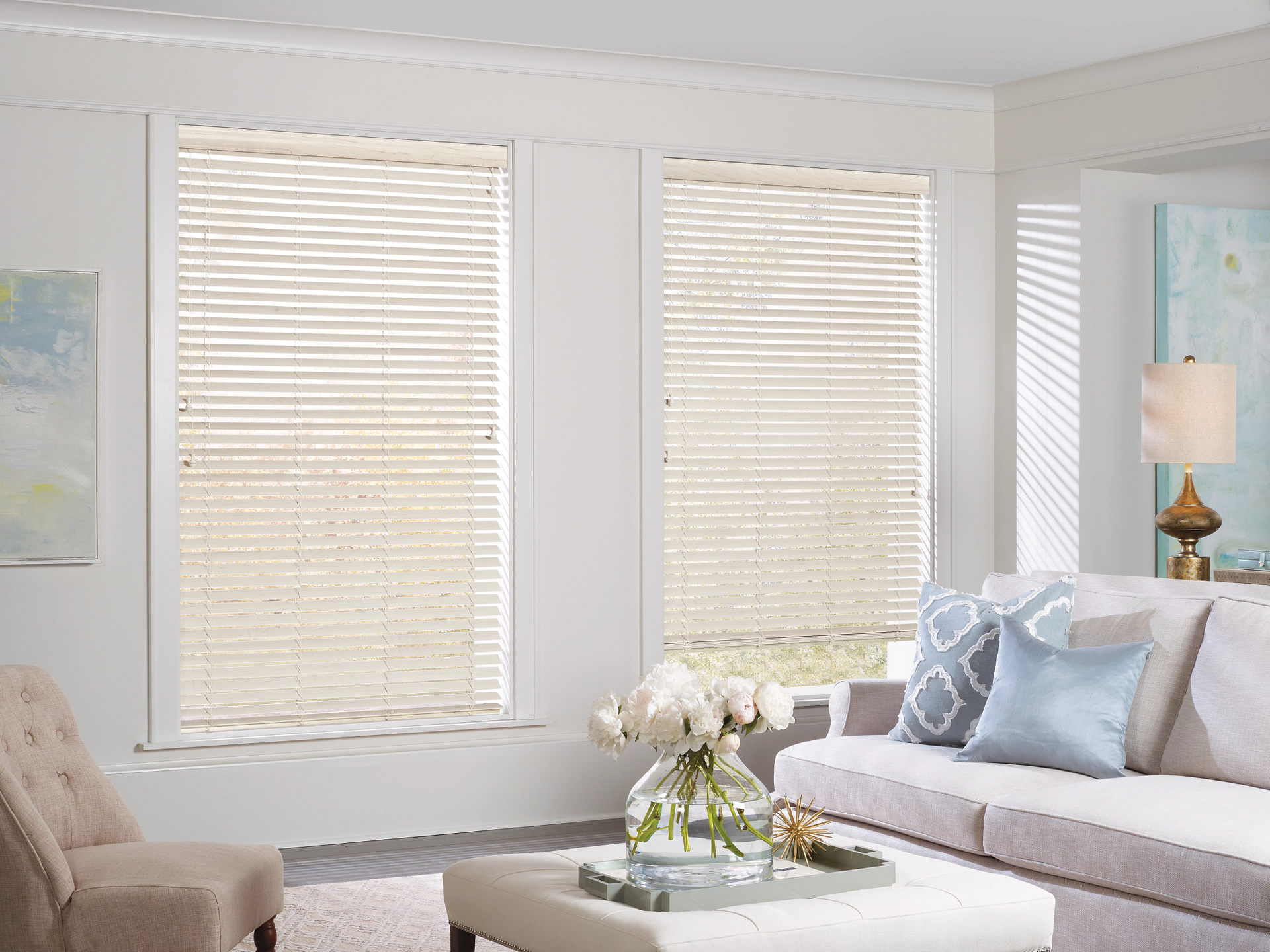 White Hunter Douglas EverWood® Faux Wood Blinds on windows in a bright and airy living room  