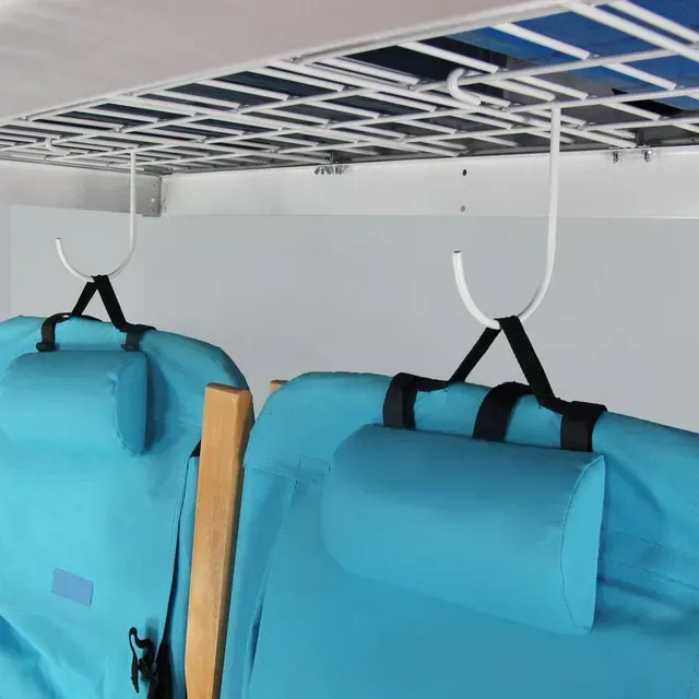Two blue foldable chairs are hanging from hooks under a overhead storage