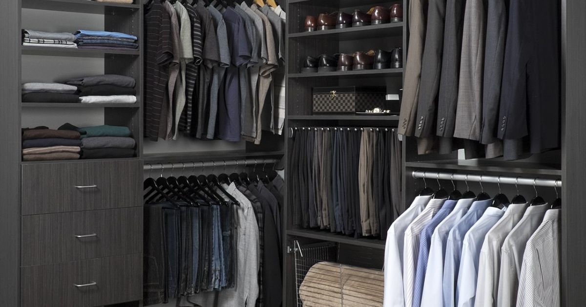 A walk in closet organizers filled with lots of clothes, pants and shoes.