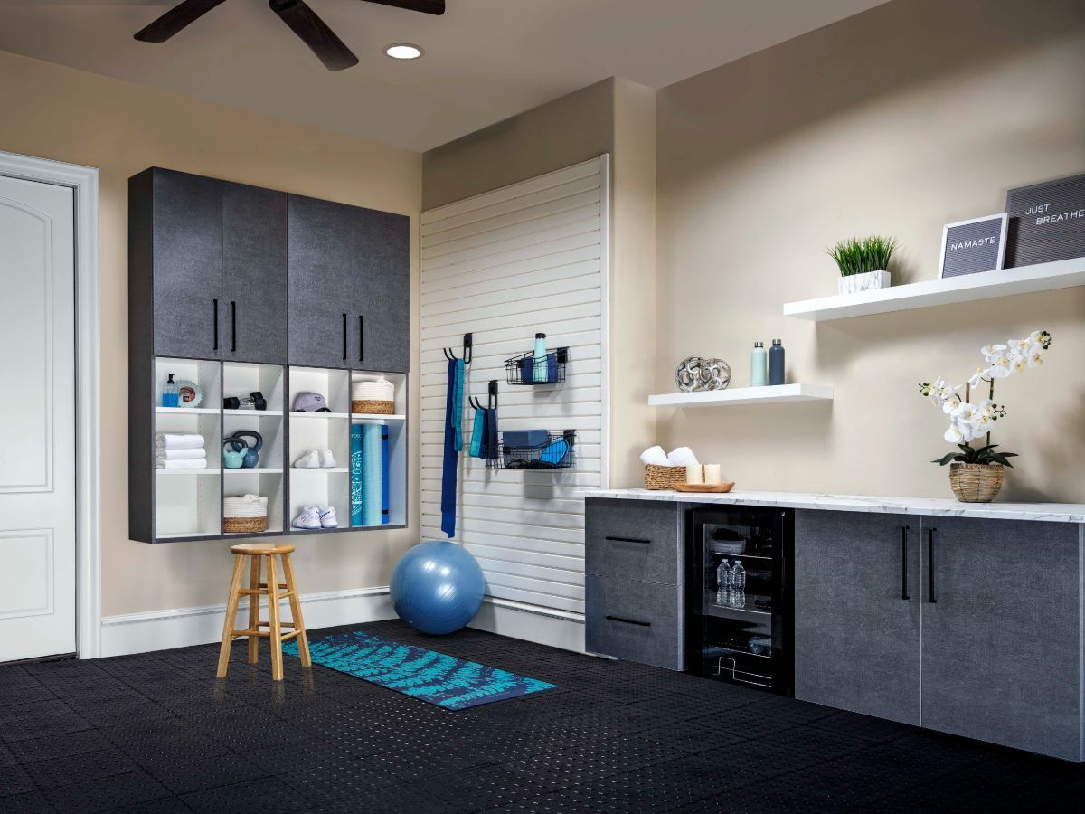 A garage yoga studio with cabinets and accessories hang on the wall