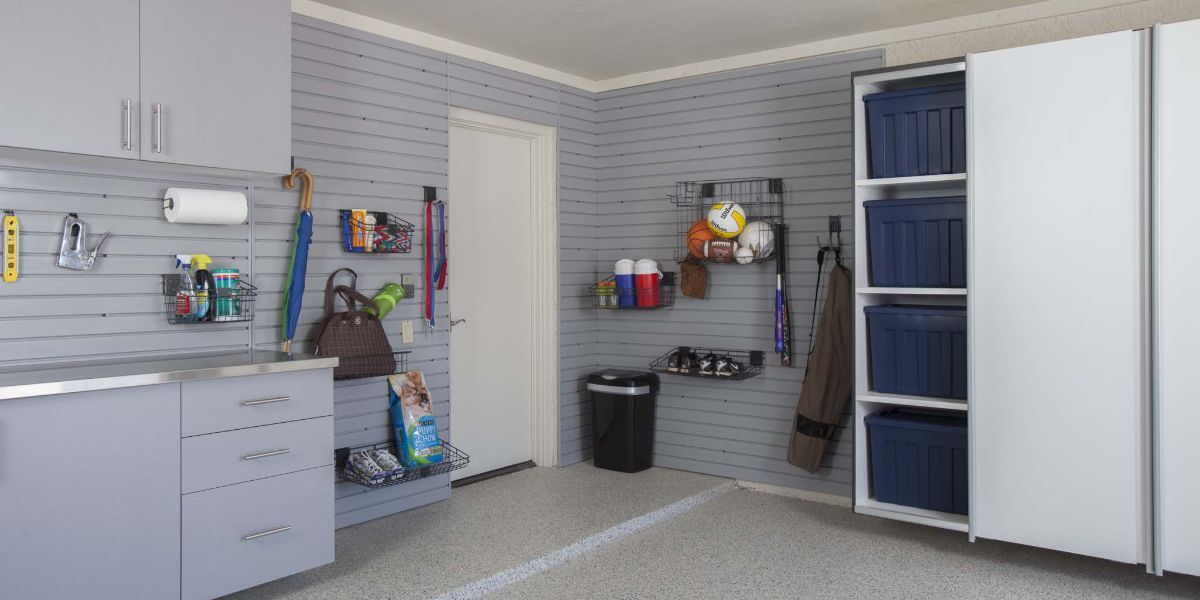 A garage with lots of storage space and a sink.