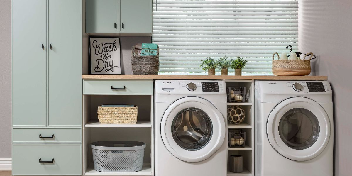 A laundry room with a washer and dryer and a window.