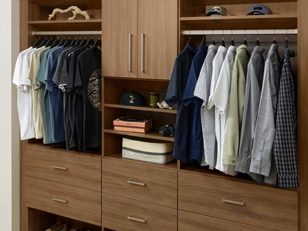 A reach in closet filled with lots of clothes and hats