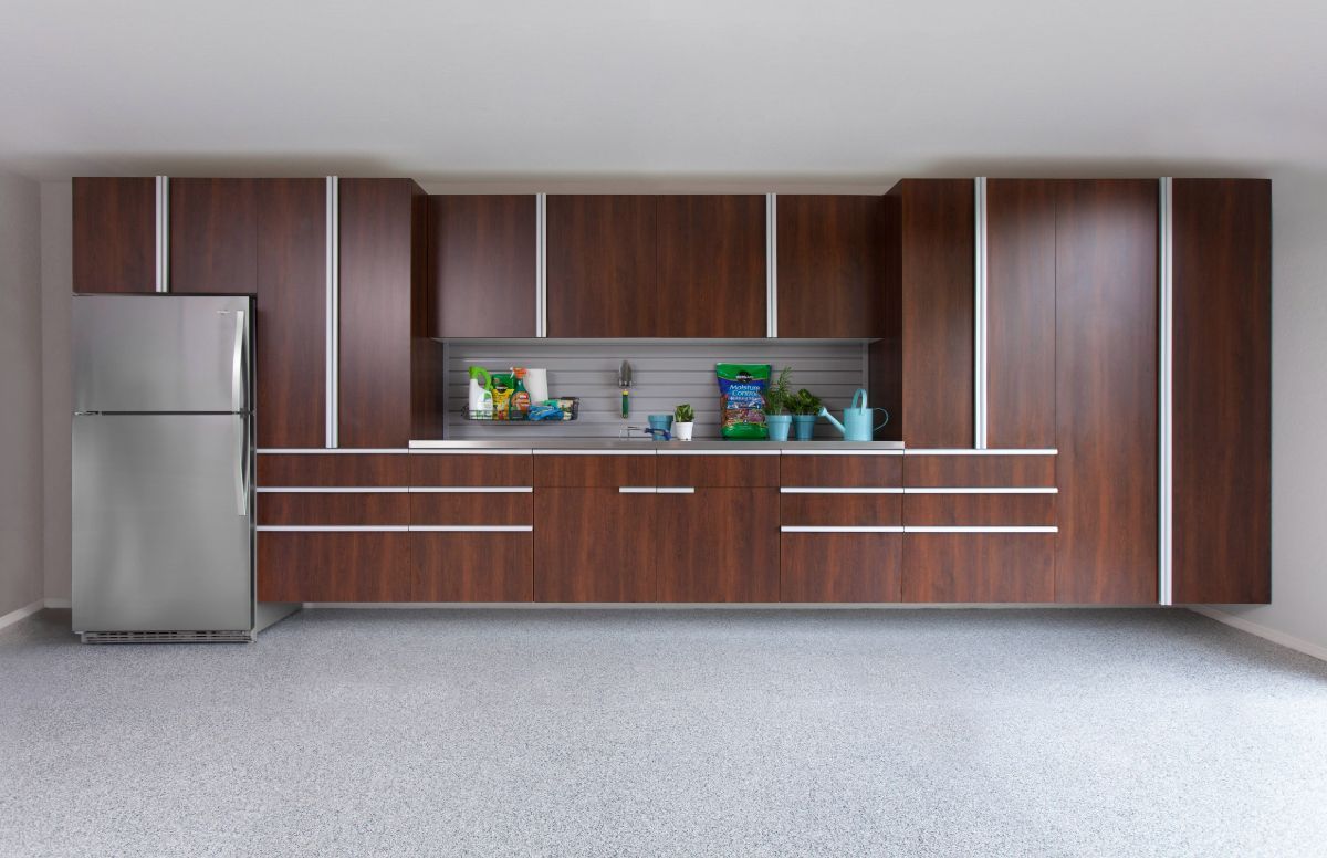 A kitchen with wooden cabinets and a stainless steel refrigerator