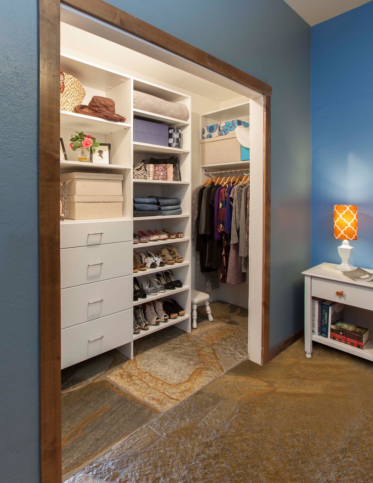 A bedroom with blue walls and a walk in closet