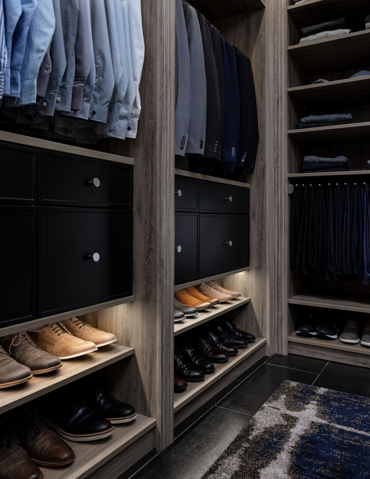 A walk in closet filled with clothes and shoes.