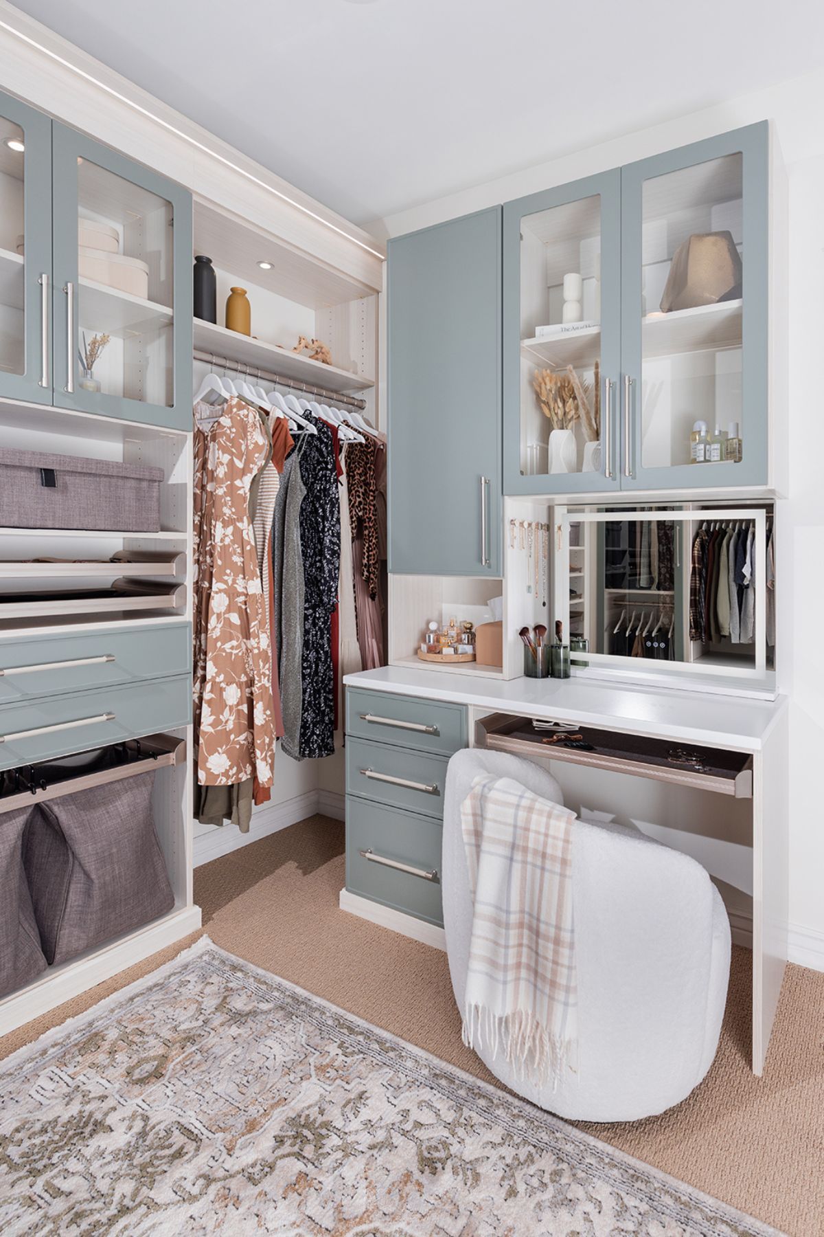 A walk in closet with a desk , chair , and mirror.